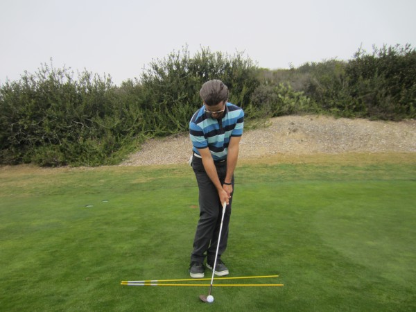 Note the forward handle, open club face and open shoulders parallel to the feet line.