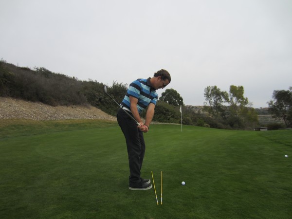 Note how the hands and handle are at thigh level while the golf club is at shoulder level.