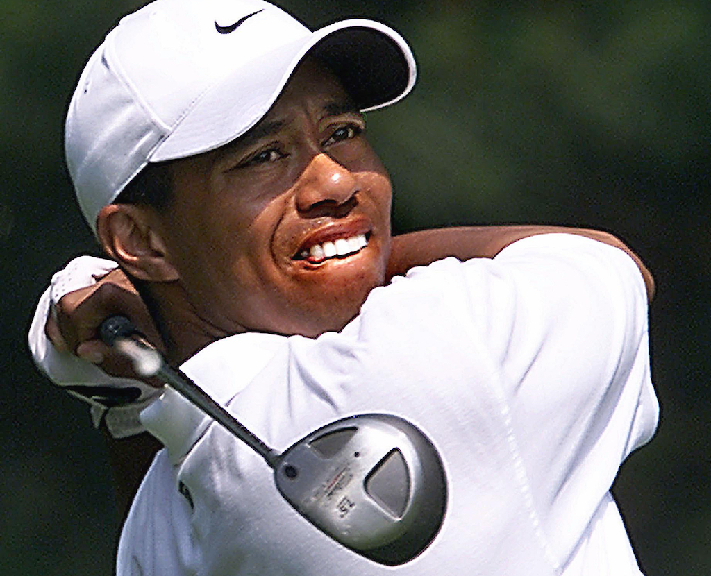 Tiger Woods of the US watches his tee shot on the